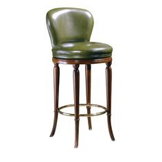 an upholstered stool with a green leather seat