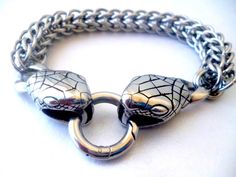 Stainless steel chainmaille bracelet Snake for men. Length is 23 cm /9.06 inch./. Chainmaille is an ancient techique, created by the Celts and used for the armours of the knights. Nowadays it is used to make jewelry. I weaved this bracelet ring by ring in a weave called Full Persian 6 in 1. This is one of my favourite weaves for men. It is made of solid stainless steel 316 rings. It is hypoallergenic and it will not tarnish or fade. You can clean it with soap water. The clasp is also made of stainless steel and represents two snake heads. This bracelet is the perfect gift for the 11th wedding anniversary, as it is the Steel anniversary! It represents the strength of the metal, as the strength of the feelings. It will come in a beautiful carton box - ready gift. Mens Chainmail Bracelet, Adjustable Stainless Steel Bracelet With Jump Ring, Silver Chainmail Stainless Steel Chain Bracelet, Silver Chainmail Chain Link Bracelets, Box Chainmail Bracelet, 11th Wedding Anniversary, Bracelet Viking, Viking Bracelet, Chainmaille Bracelet