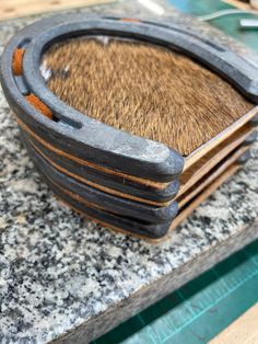 a stack of wooden plates sitting on top of a counter