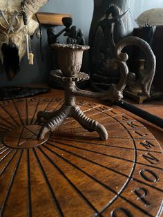 a wooden table topped with a metal object on top of it