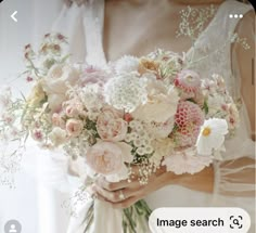 a woman holding a bouquet of flowers in her hands with the caption image search