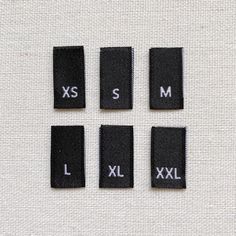 four pieces of cloth with the letters s, m, l, and xx on them