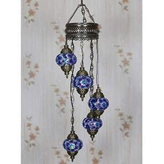 an ornate chandelier with blue glass balls hanging from it