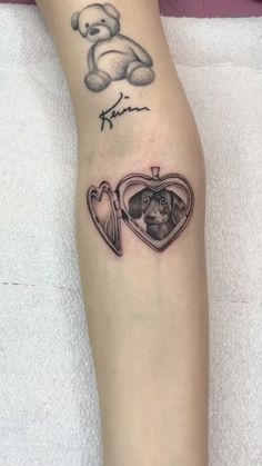 a person with a tattoo on their arm and a dog in a heart shaped pocket