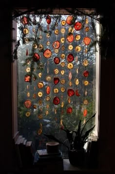 a window covered in lots of different types of glass plates hanging from it's side