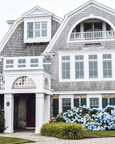 a house with blue flowers in front of it