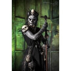 a woman dressed up as a skeleton holding a sculler and two skulls on her arm