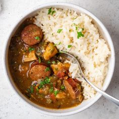 two bowls filled with rice and sausage stew