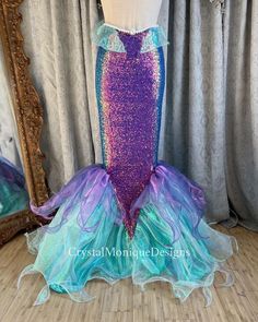 the mermaid costume is displayed in front of a mirror