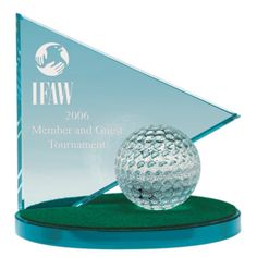 a glass trophy with a golf ball on it