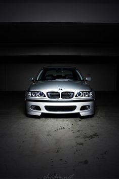 a silver car parked in a dark garage