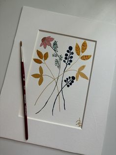 a card with some flowers on it next to a pencil