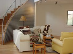 a living room filled with furniture and a stair case