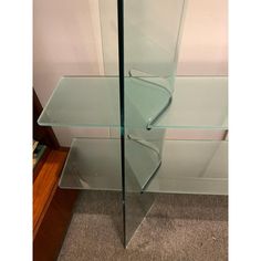 a glass shelf sitting on top of a carpeted floor