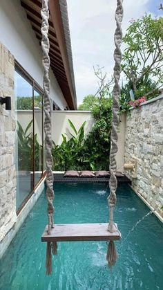 a pool with a swing hanging from it