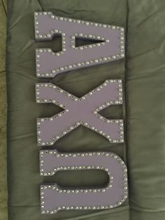 the letters are made out of plastic and have rivets