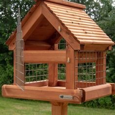 a wooden bird house with a metal roof