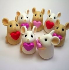 a group of toy mice with hearts in their mouths