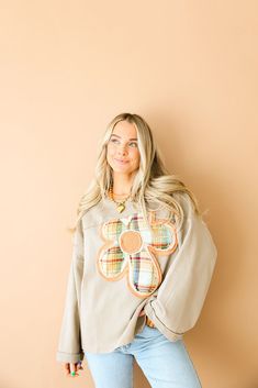 a woman standing in front of a tan wall