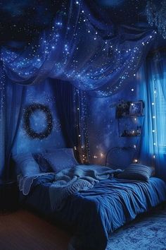 a bedroom decorated in blue with stars on the ceiling and curtains hanging from the ceiling