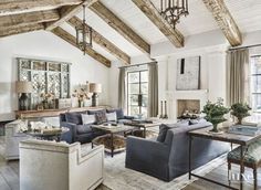 a living room filled with lots of furniture next to a fire place in a house