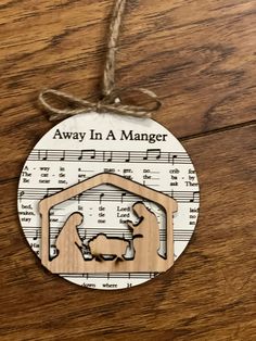 Laser engraved ornament on whiteboard material. Back side plain black. Tied with twine and bow. 1/4” thick. 3.5 wide Christmas Nativity Sheet Music Ornaments. Christmas Hymn Ornament, Christmas Crafts With Sheet Music, Hymn Christmas Ornaments, Christmas Ornaments Made From Sheet Music, Christmas Song Ornaments, Christmas Music Crafts, Diy Christian Ornaments, Music Themed Christmas Tree, Christian Christmas Ornaments Diy