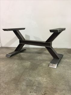 a black metal table sitting on top of a cement floor