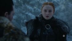 the game of thrones character is looking at another person with red hair and a fur collar