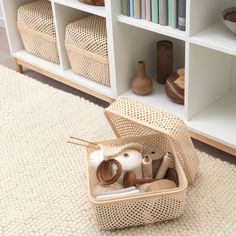 an open suitcase sitting on top of a rug in front of a bookshelf