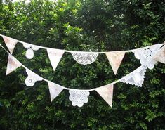 a white lace banner hanging from a tree