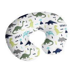 a neck pillow with dinosaurs and trees in the background on a white background that says kanu