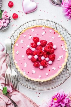 raspberry and white chocolate tart topped with marshmallows on a wire rack