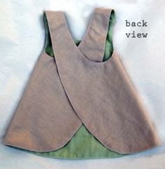 the back view of a dress made out of fabric, with green linings on it