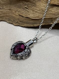 Keep the memories of your loved ones close to your heart with this beautiful Purple Amethyst Heart with Angel Wings Cremation Urn Necklace. It is designed to hold a small amount of your loved one's ashes, ensuring that they are always with you. Crafted with high-quality materials, this Memorial Jewelry features a stunning purple amethyst heart that represents love and healing. The angel wings symbolize protection and guidance, making this necklace a touching tribute to your loved ones. This Cremation Urn Necklace is easy to fill and comes with a small funnel to help you transfer the ashes. It is also suitable for holding a lock of hair, dried funeral flowers or any other small memento that reminds you of your loved one. Aside from being a meaningful way to remember your loved one, this Ang Heart With Angel Wings, Pet Cremation Jewelry, Cremation Necklaces, Amethyst Heart, Urn Pendant, Urn Jewelry, Urn Necklace, Heart Shaped Necklace, Human Ashes