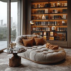 a living room filled with lots of furniture and bookshelves next to a window