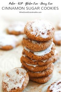 a stack of cookies with icing and powdered sugar on top sitting on a table