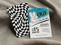 a black and white checkered cloth with a hand drawn peace sign on it next to a concert ticket