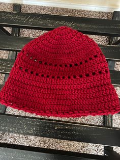 The Bucket Hat is back. This is a handmade crochet hat that is designed to fit snugly around your head and to protect your head and face from the sun's rays. The hat is made with a brim that can be worn turned up or down to suit your purpose. It is very stylish and reminiscent of the 70"s. Color-Burgundy Size-Small to medium Length-   8 inches Diameter of the top (bowl of the hat) --6 inches Brim is 2 1/2 inches wide Body of the hat is 20 inches wide Machine wash and dry Acrylic One Size Brimmed Crochet Hat For Outdoor, Brimmed Crochet Hat For Outdoor One Size, Outdoor Crochet Hat With Short Brim, Adjustable Crochet Sun Hat For Outdoor, Red Crochet Wide Brim Hat, Red Wide Brim Crochet Hat, Red Hand-knitted Crochet Hat For Beach, Adjustable Brimmed Crochet Hat In Cotton Yarn, Outdoor Crochet Bucket Hat