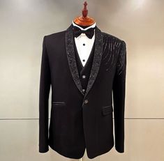 a black tuxedo jacket and bow tie on display