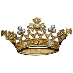 Circa 1890s This Belle Epoque openwork gold brooch is finely modeled as a royal crown embellished with pearls, old mine and rose cut diamonds. The three principal diamonds are bright white (E-F color) old mine cut stones with approximate weight of 0.23 ct, 0.19 ct, 0.17 ct (VS1, VS2, SI2 clarity). Estimated total diamond weight is 1.06 carat. Length 55 mm (2 3/16 in.) Height 29 mm (1 1/8 in.) The brooch is almost certainly a royal presentation piece. Antique Crown, Crown Brooch, Diamond Crown, Garnet And Gold, Gold Brooch, Antique Brooches, Diamond Brooch, Gold Brooches, Gold Crown