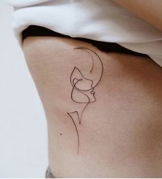 a woman's lower back with a tattoo on her left side and the outline of a female head