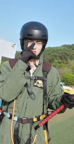 a man wearing a helmet and holding a rope