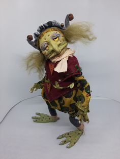 a creepy looking doll with long hair and green eyes