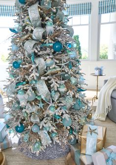 a decorated christmas tree with blue and silver ornaments