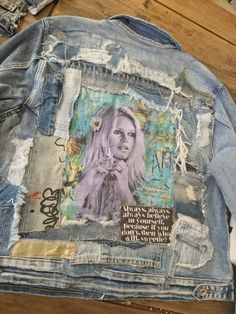 a jean jacket that has been altered to look like a woman's face on it