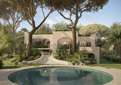 an outdoor pool surrounded by trees and plants