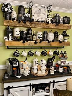 a shelf filled with coffee cups and halloween decorations