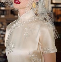 a woman wearing a veil with flowers on it