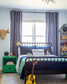 a bed room with a guitar sitting on top of it