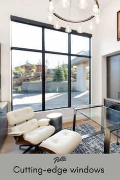 a living room filled with furniture and a large window covered in lots of glass doors